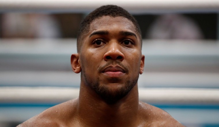Anthony Joshua pays respects to friends killed in road crash