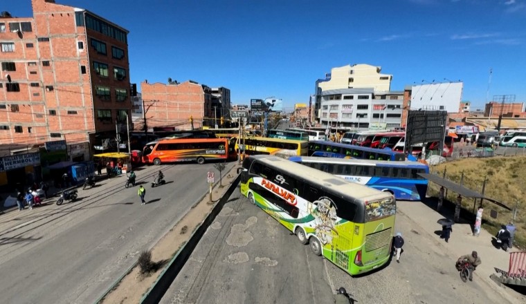 Buses block off roads in Bolivia as transport workers strike over fuel