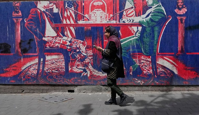 Iranians at home divided between hope for regime change and war fears