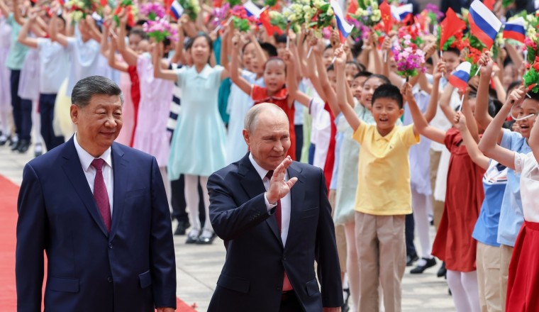 Putin and Xi hail their high-level ties and growing energy trade as they meet in Beijing