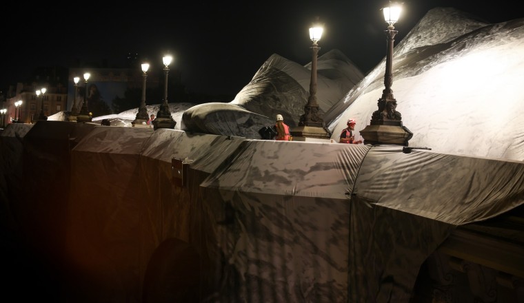 French artist JR begins his giant ‘cave’ art inflation over Paris’ oldest bridge