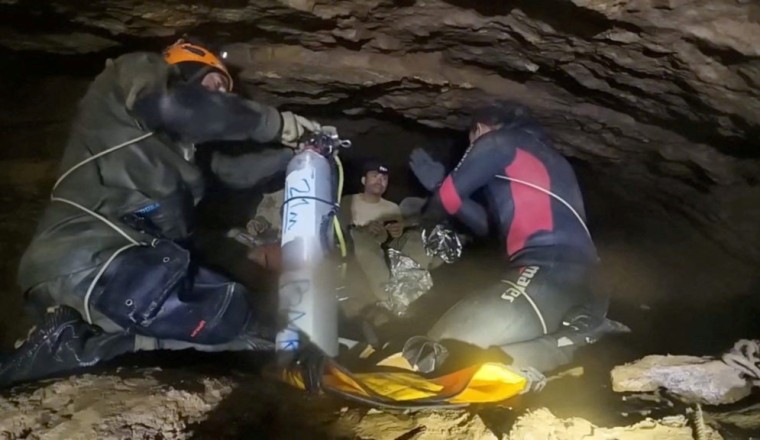 Four men rescued from flooded Laos cave as search continues for 2 others